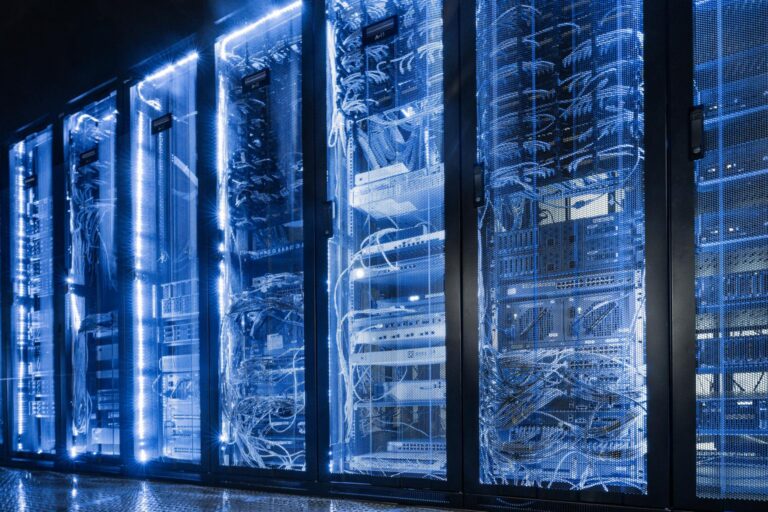 Modern data center with illuminated server racks and high-density IT infrastructure