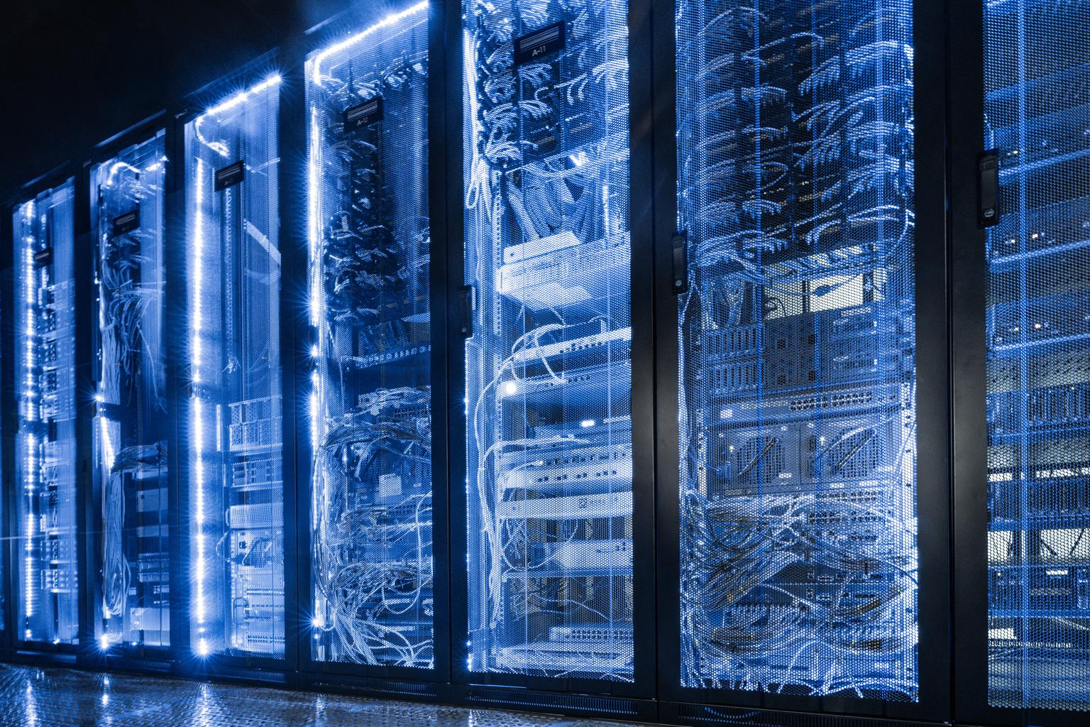 Modern data center with illuminated server racks and high-density IT infrastructure